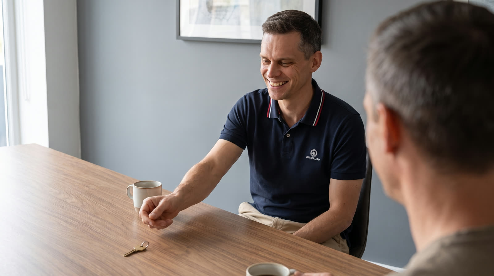 A key labelled with your company name being handed across a table
